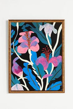 a painting with pink and blue flowers on a black background is hanging on a wall