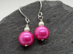 Elegant sterling silver and bright pink faux pearl drop earrings, handmade in the UK. **Buy with confidence - I have a 14 day no-quibble returns policy on all my items** These dainty earrings feature glass pearls in a pretty, vibrant shade of fuschia pink, accented with tiny frosted silver plated  beads. They would be lovely as bridal earrings for a summer wedding. They could be dressed up for a formal occasion or worn more casually for a daytime look. Their clean lines give them a fresh modern Formal Handmade Pink Earrings, Pink Pearl Drop Earrings As Gift, Hypoallergenic Pink Pearl Earrings As Gift, Handmade Pink Pearl Earrings For Party, Handmade Pink Drop Earrings, Hypoallergenic Pink Pearl Earrings For Gift, Pink Round Pearl Earrings With Ear Wire, Festive Pink Dangle Pearl Earrings, Pink Pearl Earrings With Round Ear Wire