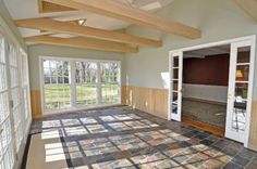 an empty living room with large windows and carpeted flooring on the ground in front of sliding glass doors