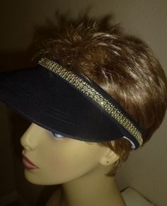 Whether you wear this  Black sun visor to play golf or tennis, or just as an accessory, it is sure to bring compliments. It is a comfortable open back cotton visor with white terry cloth lined around inside brim for comfort .The visor is hand decorated with 2 thin rows of  square shaped gold colored rhinestones  around the brim. Happy Customer- January 2015 I anticipate getting a lot of use from this well-made little visor since I wear a lot of black. It looks quite classy with its tiny rhinesto Tennis Visor, Rhinestone Trim, Sun Visor, Play Golf, Summer Hats, Hand Decorated, Terry Cloth, Sun Hats, Festival Captain Hat