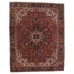 an antique persian rug with red, blue and beige colors on the center piece is shown