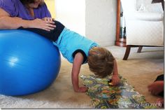 a woman and child playing on an exercise ball