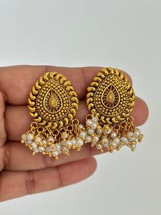 Antique Pearl Gold Studs Earrings /Indian Studs/Indian Earrings/Indian Jewelry/Pearl Stud/Bridal Jewelry/Indian wedding/South Indian Jewelry Style 1 Height = 38 Mm || Width = 30 Mm Tops Antique Earring Style 2 Height = 35 Mm || Width = 34 Mm Tops Antique Earring This is 100% Handmade jewelry. So Color, shades, texture displayed may slightly vary from the actual product due to digital image limitations. We request you to consider these minor variations. Please expect the possibility of some sligh Temple Jewelry Style Round Earrings For Marriage, Temple Jewelry Round Earrings For Marriage, Temple Jewelry Earrings For Marriage, Temple Jewelry Style Pearl Drop Earrings, Elegant Chandbali Earrings For Marriage, Traditional Pearl Drop Earrings For Anniversary, Round Pearl Earrings For Temple Jewelry, Temple Style Round Pearl Earrings, Temple Jewelry Style Bridal Earrings With Pearl Drop