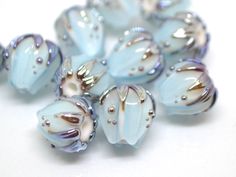 some blue glass beads on a white surface