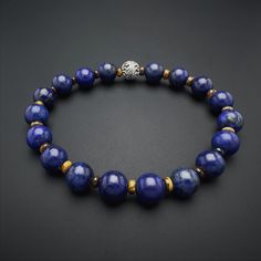 Introducing our Men's Lapis Lazuli Beaded Bracelet, a harmonious blend of style and spirituality. This gemstone bracelet, meticulously crafted with natural Lapis Lazuli beads, exudes a minimalist charm that effortlessly complements any ensemble. The 925 Sterling Silver detailing adds a touch of sophistication, making it a versatile accessory for any occasion. Designed for both style and strength, this stretch bracelet features Yellow Tiger Eye gemstones, renowned for their grounding properties. Polished Beads Lapis Lazuli Round Bracelets, Round Lapis Lazuli Bracelets With Polished Beads, Polished Beads Lapis Lazuli Bracelets, Lapis Lazuli Beaded Bracelets With Polished Round Beads, Howlite Bracelet, Bracelets Patterns, Lapis Lazuli Bracelet, Tiger Eye Gemstone, Lapis Lazuli Beads