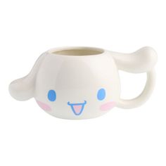 a white mug with blue eyes and ears