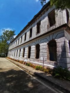 an old stone building with windows and shutters