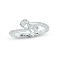 a white gold ring with two hearts and the words together forever