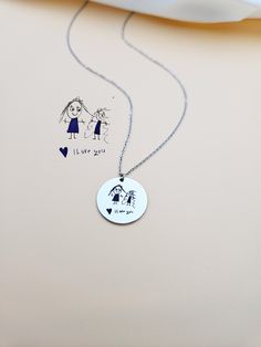 Kids Drawing Necklace, Children Handwriting Necklace for Mom, Custom Child Artwork Jewelry, Personalized Gift for Grandma, Keepsake Jewelry. Turn your children's drawing or writing into a necklace. This necklace is not just an accessory, it's a precious keepsake that celebrates the boundless creativity of your little one. Your child's cherished drawing forever preserved in a stainless steel charm. Each line, every curve, and all the details are meticulously engraved with laser precision, ensuring that the essence of your child's artwork is beautifully preserved. HOW TO ORDER Scan or take a picture of the design, use the ASK A QUESTION OR CONTACT SHOP OWNER button to send us your design. Material: Stainless Steel, Gold or Rose Gold Plated Stainless Steel. Finish: Stainless Steel, Gold, Rose Artistic Personalized Round Necklace, Artistic Personalized Necklace, Artistic Personalized Round Pendant Necklace, Handmade Charm Necklace For Birthday And Mother's Day, Artistic Stamped Jewelry For Gifts, Artistic Stamped Jewelry As Gift, Handmade Mother's Day Charm Necklace With Round Pendant, Artistic White Necklace For Gift, Personalized Round Artistic Jewelry