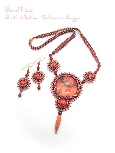 This necklace is created around a beautiful glass cabochon with a floral print. Soft red, reddish brown and salmon charm any woman and the pleasant design of this unique piece is sure to draw compliments! Necklace length:  51 cm (20 inch) Pendant: 5,5 x 10 cm (2.16 x 3.9 inch) Colors: red, reddish brown, salmon, white Material: glass beads in various shapes (Miyuki, Preciosa), glass cabochons Clasp: rose gold plated magnetic clasp Backing with dark red ultrasuede Weight: 41 grams Attention: This Red Round Beads, Gems And Cabochons For Gifts, Bohemian Red Beads Gems And Cabochons For Gifts, Bohemian Red Beads And Gems For Gifts, Embroidery Necklace, Soft Red, Flower Motif, Reddish Brown, Red Bead, Glass Bead Necklace