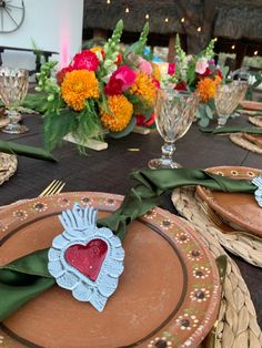 the table is set with plates and place settings