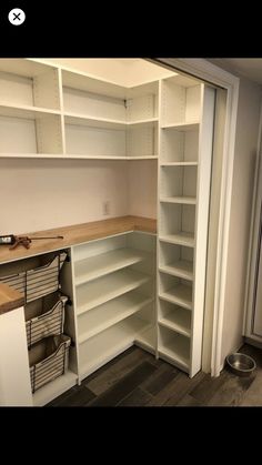 an empty pantry with lots of shelves and bins