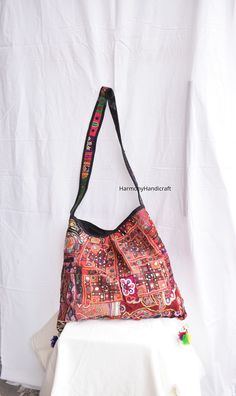 Welcome to HarmonyHandicraftCo Vintage banjara hand embroidery shoulder bag is large enough to hold everything you need throughout your day, Made of antique hand-embroidery. Thread textiles, with intricate embellishments, bag is truly unique. Size in Inches ( Approx ) Height with handle  31 Inches Bag Height - 14 Inches Width - 19 Inside Pocket - 1 Outside Pocket - No Very colorful and striking color purse, It can be a unique gift for girls, girl friends, sisters, daughters. Housewives, and can a perfect match with any of dress code. Note:- You can hand wash in cold water and hang to dry or use wet wipes to clean them. Banjara tote bag, Afghani tote  bag, Afghani bag, Banjara shoulder bag, embroidery bag, Tote bag, Handmade bag, Boho bag, Vintage Indian handmade bag, Banjara bag, Large bag Afghani Embroidery, Unique Gifts For Girls, Woman Shoulder, Embroidery Bags, Patchwork Bags, Handmade Bag, Boho Bag, Large Bag, Dress Code