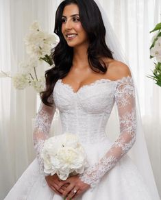 a woman in a wedding dress holding a bouquet