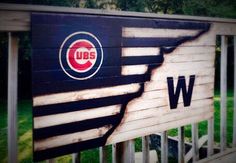 the chicago cubs logo is painted on a wooden fence