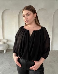 The Curve Draped Chiffon Blouse is a simple, elegant, and feminine top, great for a night out or under a blazer for a snappy, smart-casual look. The flattering elastic neckline and notch at the bust will make this plus size top a standout in your wardrobe, plus it comes in three great colors —black, white, and mocha. This top features long sleeves with elastic at the wrists, an elastic neckline, a cutout at the bust, and a draping silhouette. The outer material is a non-stretchy, woven chiffon a Formal Chiffon V-neck Blouse, Formal V-neck Chiffon Blouse, Chic Chiffon Tops For Work, Chiffon V-neck Top For Night Out, Chic Chiffon Tops For Night Out, Flowy Chiffon Blouse For Work, Chic Chiffon Blouse For Night Out, Chic Flowy Top For Night Out, Chic Flowy Blouse For Workwear