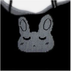 a black and white photo of a bag with an image of a rabbit on it