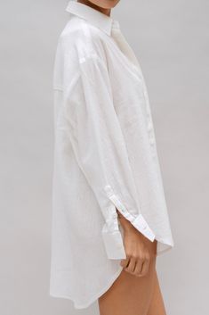 The Lilo Shirt is a timeless classic, crafted from lightweight fabric with a captivating texture reminiscent of rippled water. Whether you're unwinding at home or embarking on a beach trip, you can effortlessly style it as a sleep dress, an oversized blouse, or a breezy cover-up. Oversized fit Drop shoulder Button up High-low hemline Semi-sheer Runs large Summer Long Sleeve Blouse With Crinkle Texture, Summer Long Sleeve Crinkle Texture Blouse, Long Sleeve Blouse With Crinkle Texture For Summer, Summer Cotton Shirt With Crinkle Texture, Summer Long Sleeve Tops With Crinkle Texture, Long Sleeve Summer Tops With Crinkle Texture, Relaxed Long Sleeve Beach Shirt, Effortless Long Sleeve Beach Blouse, Effortless Long Sleeve Blouse For Beach