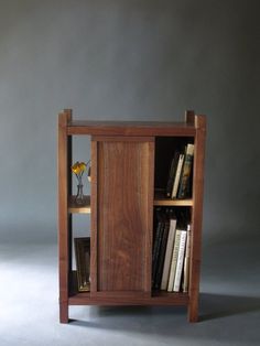 a wooden book shelf with books on it