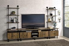 an entertainment center with shelves and a flat screen tv mounted on it's side