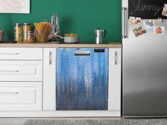 a metallic refrigerator freezer sitting in a kitchen next to a counter top with pictures on it