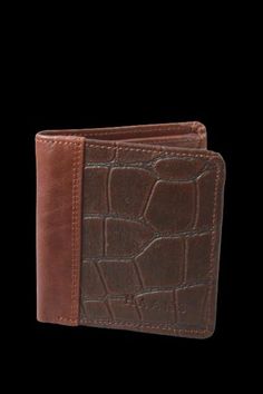 This strikingly Crocodile embossed wallet by HAANS is handcrafted using Munich tanned leather. This bifold wallet is a classic and practical accessory with multiple pockets. DIMENSIONS: L 8.5 W 0. 6 " H 3.5" Leather Wallet With Crocodile Pattern For Daily Use, Leather Bifold Wallet With Crocodile Pattern, Daily Use Leather Wallet With Crocodile Pattern, Leather Bifold Card Holder With Crocodile Pattern, Brown Embossed Leather Wallet, Brown Embossed Wallets For Daily Use, Brown Embossed Wallet For Daily Use, Brown Embossed Wallet, Clip Wallet