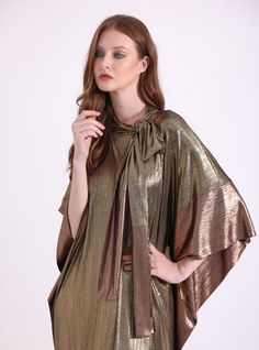 WF ATELIERMat Mat gold relax fit evening out kaftan Fabric: 100% Polyester The model wears size One size and is 177 cm tall. Garment length: 145 cm Gold V-neck Kaftan For Party, Gold Silk Kaftan For Festive Season, Festive Gold Silk Kaftan, Gold Maxi Length Kaftan For Festive Occasions, Gold Maxi-length Kaftan For Festive Occasions, Festive Gold Maxi Length Kaftan, Gold Dress With Cape Sleeves For Party, Gold Party Dress With Cape Sleeves, Elegant Cape-shaped Kaftan