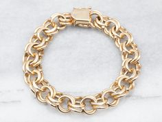 "Subtle, yet luxurious, this gorgeous bracelet is as suitable with a suit as it is with a cocktail dress. Crafted from 14-karat gold, this chain has a double link design that is sturdy on the wrist. Versatile and stylish! Metal: 14K Yellow Gold Width: 12.2 mm Length: 8 Inches Marks: \"14K(B)(B)\" Stamped on the clasp To view a video of this piece check out the link below: https://vimeo.com/808088200 SKU #: A23568 Each piece has been identified and graded by a Graduate Gemologist who has been certified by the Gemological Institute of America (GIA). We have six brick-and-mortar storefronts in Maine, Massachusetts, and New Hampshire and have been in business for over 25 years! Please visit our Shop's About Page or our website for more information about our jewelry. For questions about diamond Bypass Engagement Ring, Bracelet Layering, Gold Chain Bracelet, Link Design, Link Chain Bracelet, Heart Shaped Diamond, Diamonds And Gold, Gold Bracelet Chain, Chain Anklet