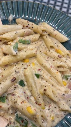 a blue bowl filled with pasta covered in sauce