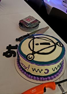 a cake that is on top of a table with scissors and other items around it