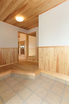 an empty room with wood paneling and white walls