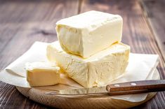 three pieces of butter sitting on top of a wooden cutting board