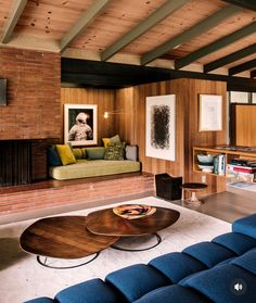 a living room filled with furniture and a fire place next to a wall mounted tv