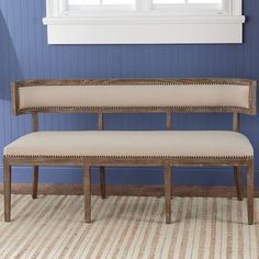 a white bench sitting in front of a window