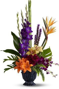 a vase filled with lots of colorful flowers and greenery on top of a white background