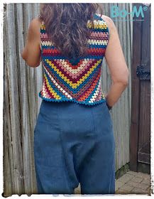 the back of a woman's top made with crochet and yarns