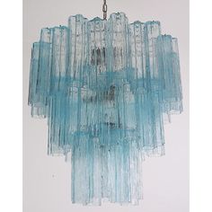 a blue glass chandelier hanging from a ceiling