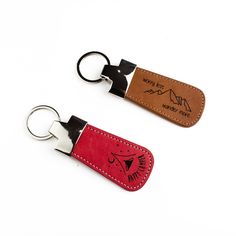 two leather keychains with the same design on each one, both have black and red stitching