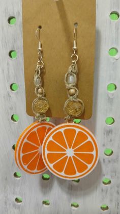 Handmade Macrame beaded earrings with 3D printed orange slice charms. Orange Resin Dangle Earrings, Orange Dangle Resin Earrings, Orange Adjustable Beaded Drop Earrings, Adjustable Orange Beaded Drop Earrings, Handmade Orange Earrings For Summer, Casual Orange Jewelry For Beach, Casual Orange Beach Jewelry, Orange Drop Earrings For The Beach, Orange Drop Earrings For Beach