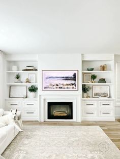 a living room filled with furniture and a fire place under a painting on the wall