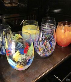 four different colored glasses sitting on top of a table