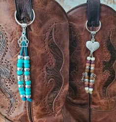 the cowboy boots are decorated with beaded and heart charms on their side, along with leather straps