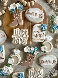 decorated cookies are arranged on a platter with the names of bride and grooms