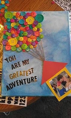 there is a book with buttons on it and the words you are my greatest adventure