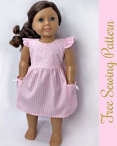 the doll is wearing a pink and white checkered dress