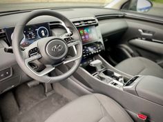 the interior of a car with steering wheel, dashboard and infotains on display