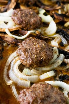 meatballs and onions are being cooked in a skillet