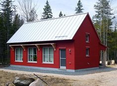 a small red house with a metal roof