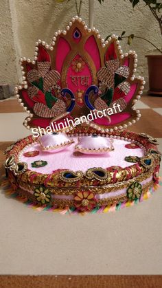 a pink and gold decorated tray on a table