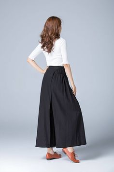 "Our black linen pants made from soft fabric has a layer, string belt on the right side make it a stylish one in the summer or fall. The linen pants style gives a skirt looking, in the summer, you can wear it as a casual skirt, party skirt or for the summer trip. Details: * black linen fabric * right zipper closure * side seam pockets * wrap pant, tie belt in the right side * ankle length * wash by hand or machine with cold water CUSTOM MADE SERVICE If you * Need a tailored clothes with your bod Black Linen Harem Pants For Spring, Black Wide Leg Pants With Side Slits, Black Linen Wide Leg Bottoms, Black Linen Wide-leg Pants, Black Linen Wide Leg Pants With Elastic Waistband, Black Wide Leg Culottes For Summer, Black Wide Leg Summer Culottes, Wide Leg Pants With Side Slits For Spring, Chic Black Linen Bottoms